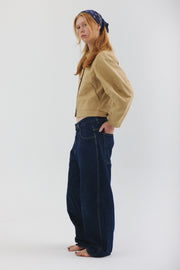 Side view of model wearing sand colored Palmetto jacket with jeans